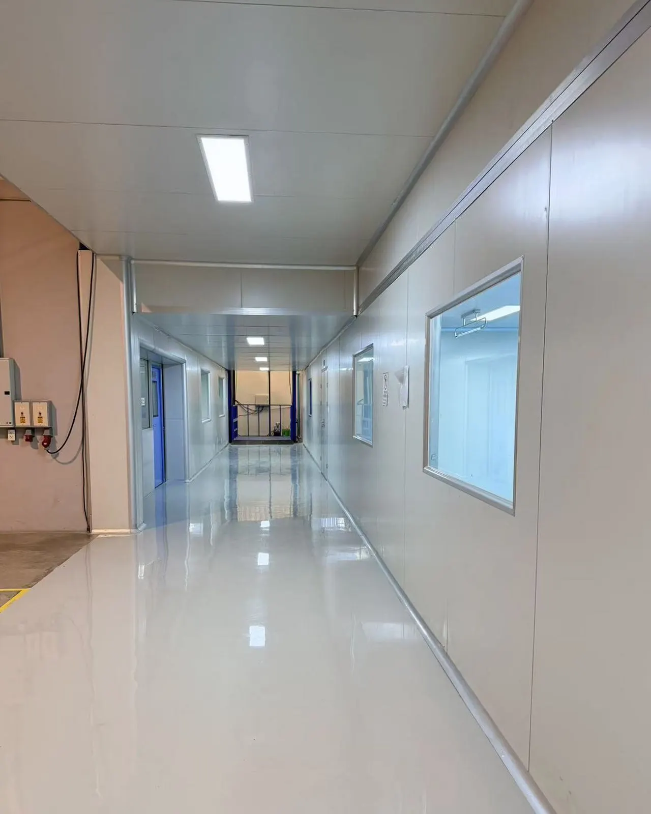 Factory corridor with viewing windows at Sawatdee Group’s Samut Prakan facility.